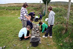 Judith Bullivant - SLEF Community Outreach Officer instructing young drystane dykers